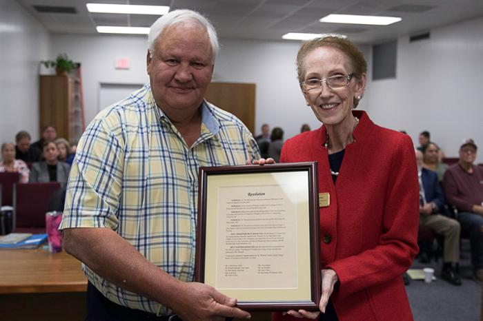 Wharton County Junior College employee Gus Wessels, left, receives an award of appreciation from WCJC President Betty McCrohan. Wessels retired after 23 years of service.