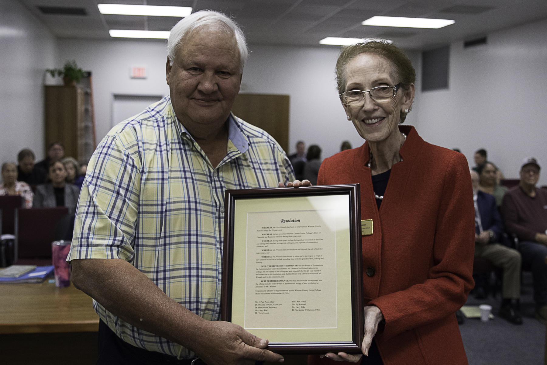 Wharton County Junior College employee Gus Wessels, left, receives an award of appreciation from WCJC President Betty McCrohan. Wessels retired after 23 years of service.