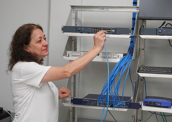 Wharton County Junior College's Dr. Muna Saqer, Program Director for the IT & Networking and Computer Science programs, demonstrates training equipment at the Wharton campus. State grant funds will enable the IT & Networking program to upgrade equipment, expand curriculum and provide scholarships. 