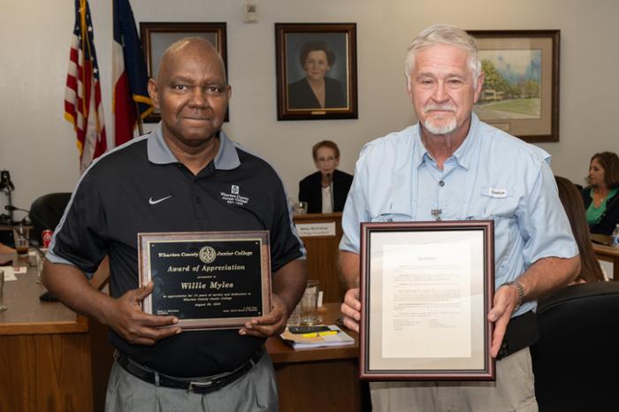 Wharton County Junior College instructor Willie Myles receives an award of appreciation for his 14 years of service to the college. 